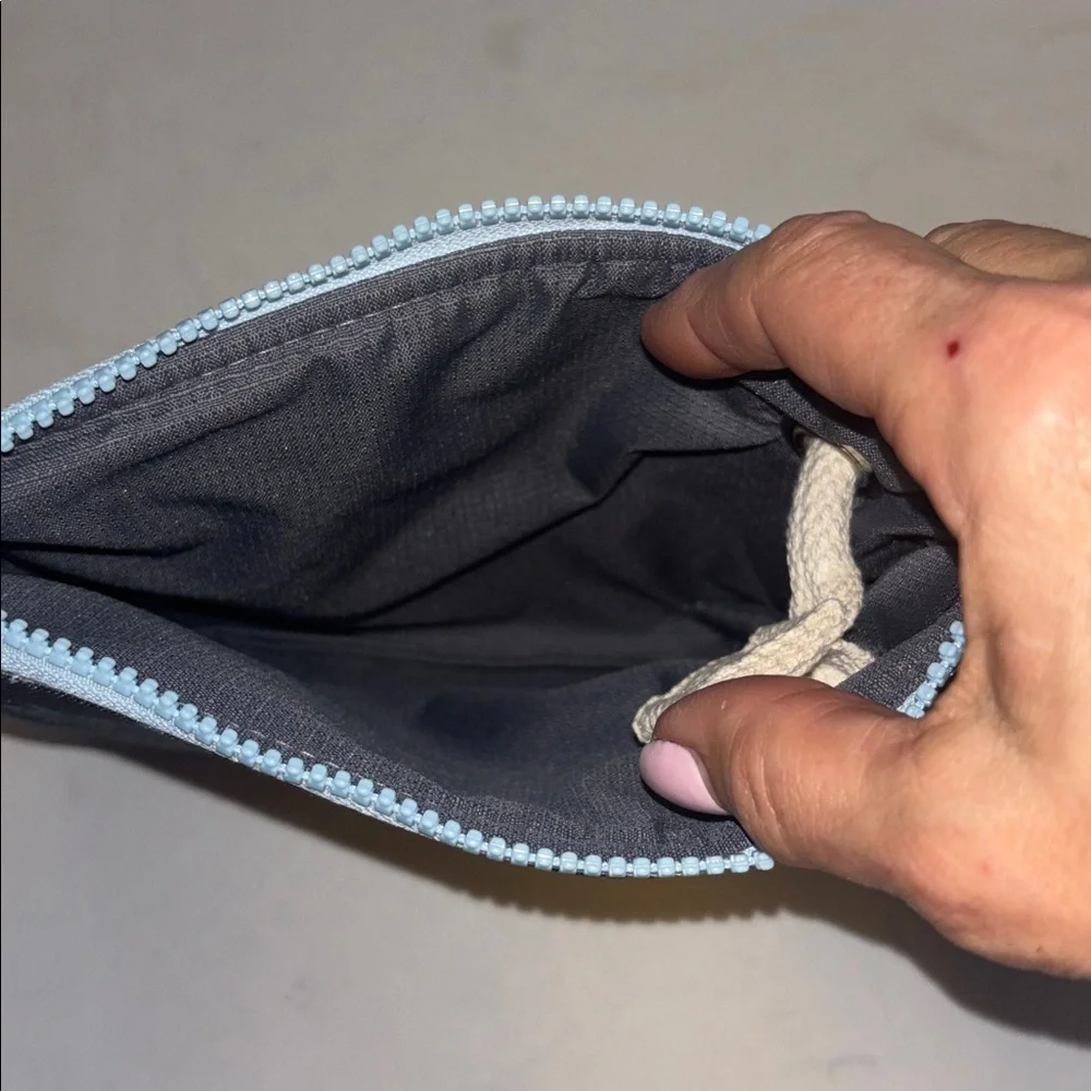 WAKES & WAVES BLUE WRISTLET WITH TURTLE DESIGN WATERPROOF CANVAS LIKE MATERIAL